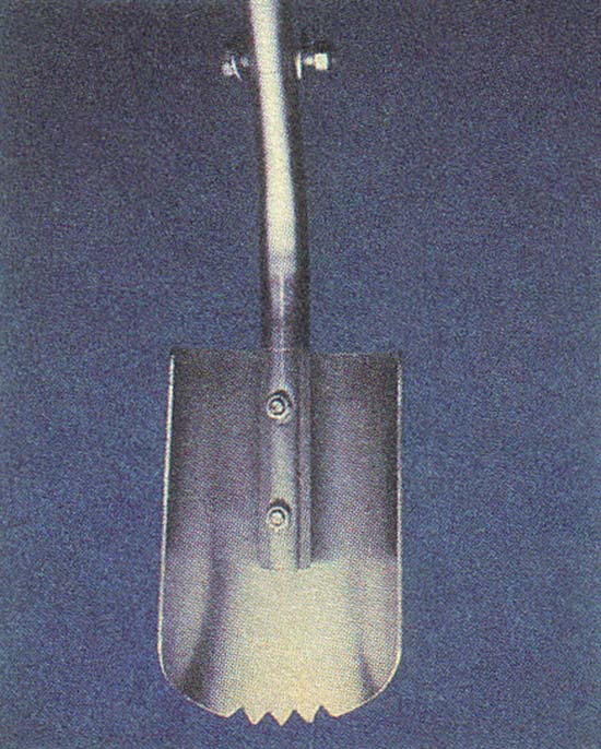 Closeup of one spade of the posthole digger. Each scoop has three teeth in its tip, made by cutting 3/8" equilateral triangles from the center of the "biting" edge. The corners are rounded to create the spade shape.